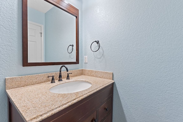 198 Prairie Springs Loop, Georgetown, TX 78626 - bathroom featuring a textured wall and vanity