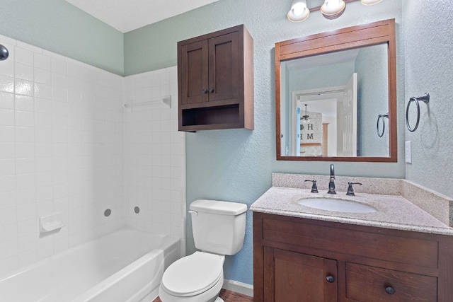 198 Prairie Springs Loop, Georgetown, TX 78626 - bathroom featuring a textured wall, toilet, vanity, and  shower combination