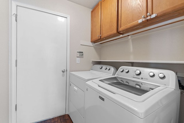 198 Prairie Springs Loop, Georgetown, TX 78626 - laundry area featuring dark wood-style flooring, cabinet space, and independent washer and dryer
