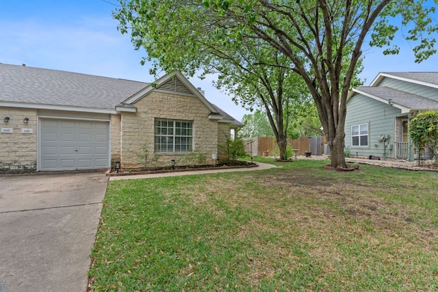198 Prairie Springs Loop, Georgetown, TX 78626 - view of front of property featuring a front lawn, stone siding, concrete driveway, and fence