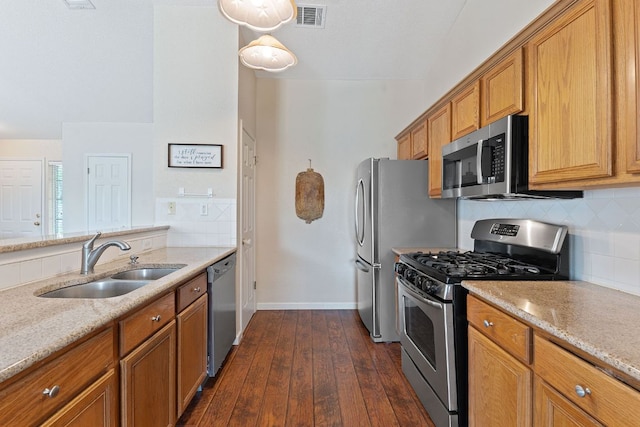 198 Prairie Springs Loop, Georgetown, TX 78626 - kitchen featuring brown cabinets, stainless steel appliances, visible vents, a sink, and decorative backsplash