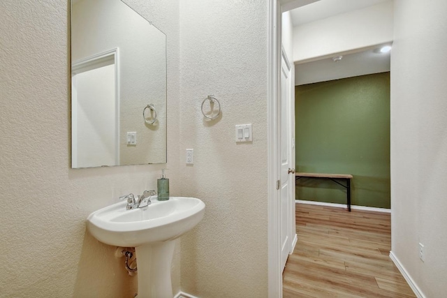 118 Esparza Dr, Bastrop, TX 78602 - bathroom with wood finished floors and a textured wall