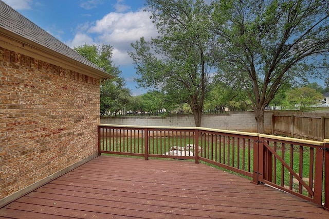 wooden terrace with a fenced backyard