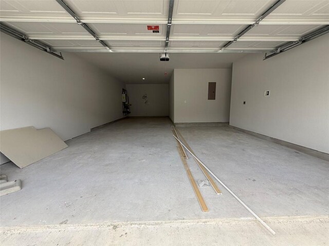 8516 Dongan Dr, Austin, TX 78744 - garage with electric panel and a garage door opener