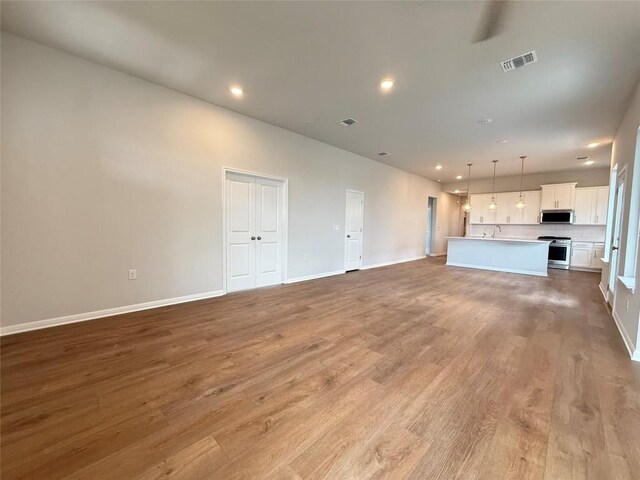 8516 Dongan Dr, Austin, TX 78744 - unfurnished living room featuring light wood finished floors and recessed lighting