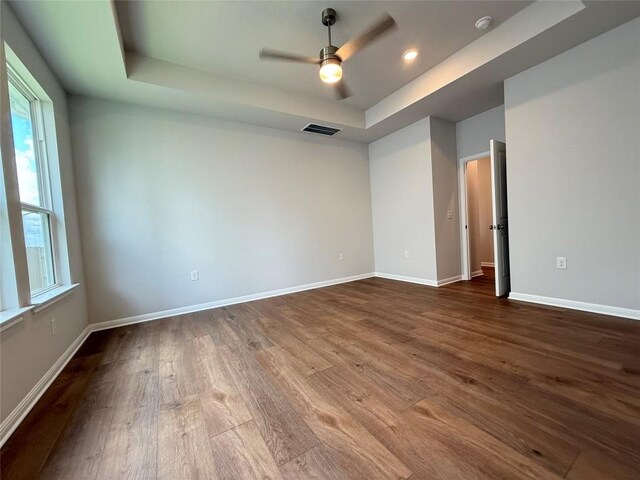 8516 Dongan Dr, Austin, TX 78744 - empty room with a raised ceiling, dark wood-style flooring, ceiling fan, a smoke detector, and recessed lighting