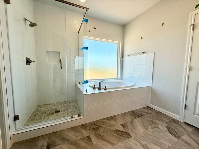 8600 Dongan Dr, Austin, TX 78744 - bathroom featuring a shower stall and a bath
