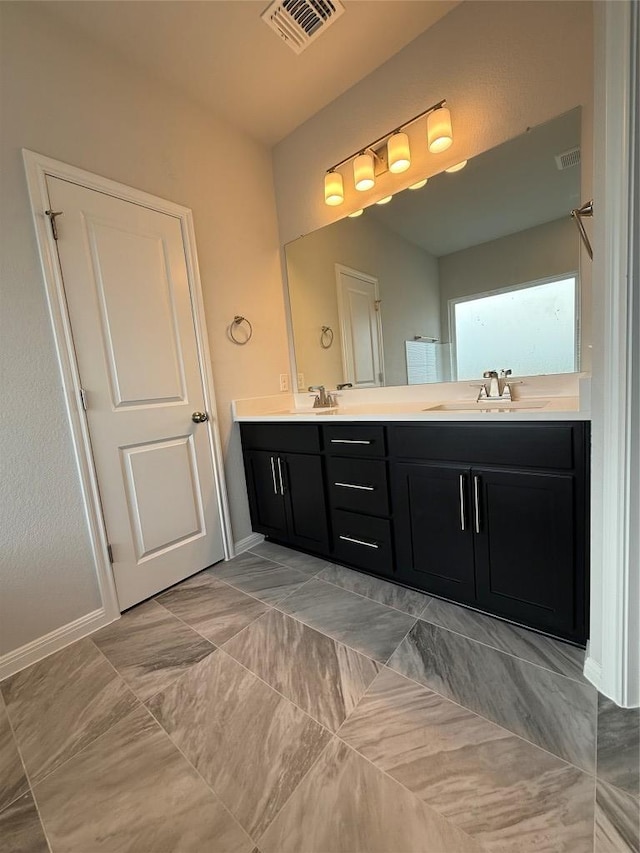 8600 Dongan Dr, Austin, TX 78744 - full bathroom with double vanity and baseboards