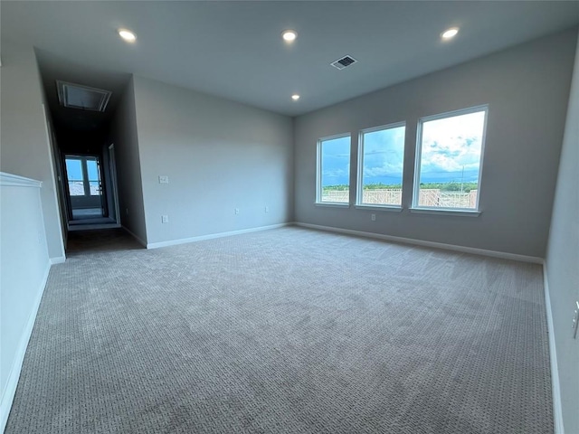 8600 Dongan Dr, Austin, TX 78744 - empty room featuring carpet flooring, recessed lighting, and attic access