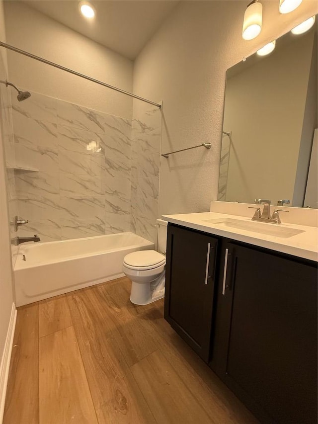 8600 Dongan Dr, Austin, TX 78744 - full bath featuring wood finished floors, shower / washtub combination, vanity, and recessed lighting