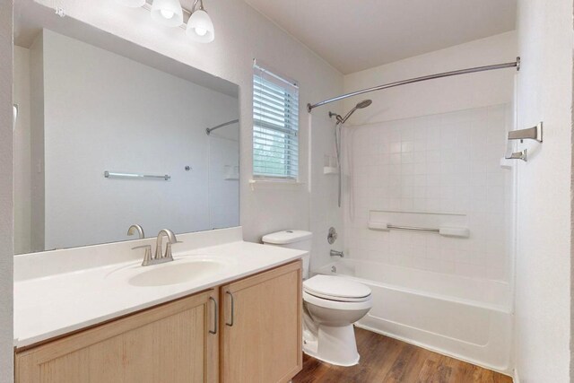 1711 Lloydminister Way, Cedar Park, TX 78613 - bathroom featuring bathing tub / shower combination, vanity, wood finished floors, and toilet