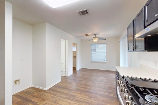 1711 Lloydminister Way, Cedar Park, TX 78613 - kitchen featuring gas range, wood finished floors, a ceiling fan, light countertops, and baseboards