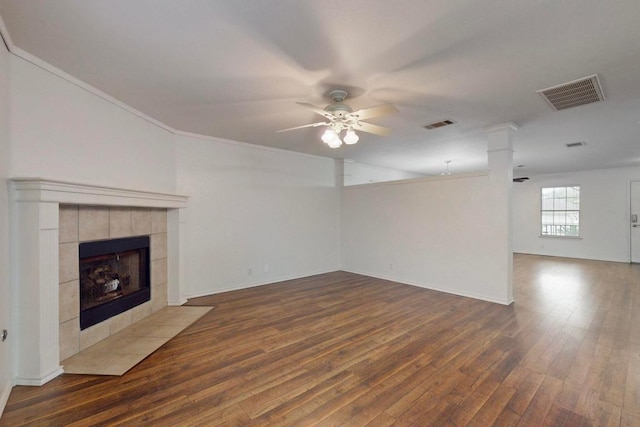 1711 Lloydminister Way, Cedar Park, TX 78613 - unfurnished living room featuring a ceiling fan, wood finished floors, a tile fireplace, crown molding, and baseboards