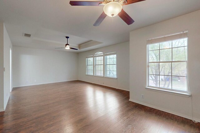 1711 Lloydminister Way, Cedar Park, TX 78613 - spare room featuring ceiling fan, dark wood-style floors, baseboards, and a raised ceiling