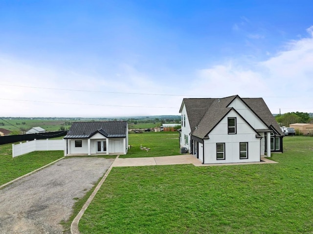 150 Huntclub Dr, Jarrell, TX 76537 - modern inspired farmhouse featuring gravel driveway, a front lawn, a shingled roof, stucco siding, and french doors