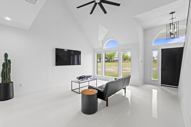 150 Huntclub Dr, Jarrell, TX 76537 - living area featuring high vaulted ceiling, a chandelier, a ceiling fan, tile patterned flooring, and baseboards
