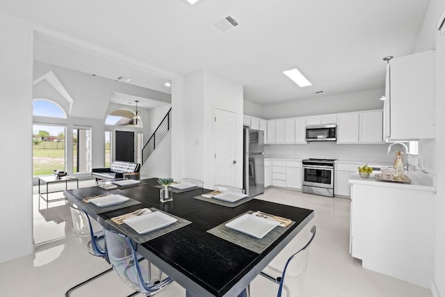 150 Huntclub Dr, Jarrell, TX 76537 - kitchen featuring appliances with stainless steel finishes, white cabinetry, light countertops, and a sink