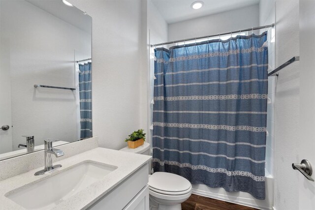 13609 Baileyfield Dr, Pflugerville, TX 78660 - full bathroom with vanity, toilet, shower / bath combination with curtain, and wood finished floors