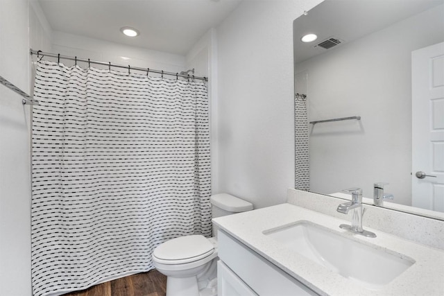13609 Baileyfield Dr, Pflugerville, TX 78660 - bathroom featuring vanity, toilet, wood finished floors, curtained shower, and recessed lighting