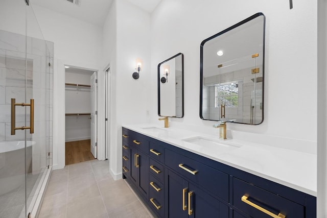 3505 Galena Hills Loop, Round Rock, TX 78681 - bathroom featuring a shower stall, double vanity, a walk in closet, and tile patterned flooring