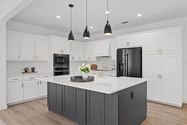 3505 Galena Hills Loop, Round Rock, TX 78681 - kitchen featuring high quality fridge, stainless steel oven, black microwave, premium range hood, and white cabinetry