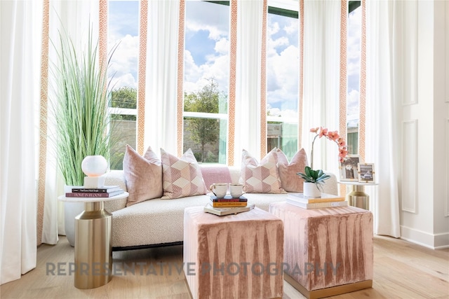 sitting room featuring baseboards and wood finished floors