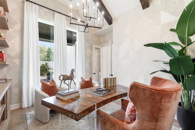 interior space with an inviting chandelier, beam ceiling, and wood finished floors
