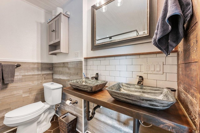 5310 Fort Clark Dr, Austin, TX 78745 - bathroom with toilet, a sink, and a wainscoted wall