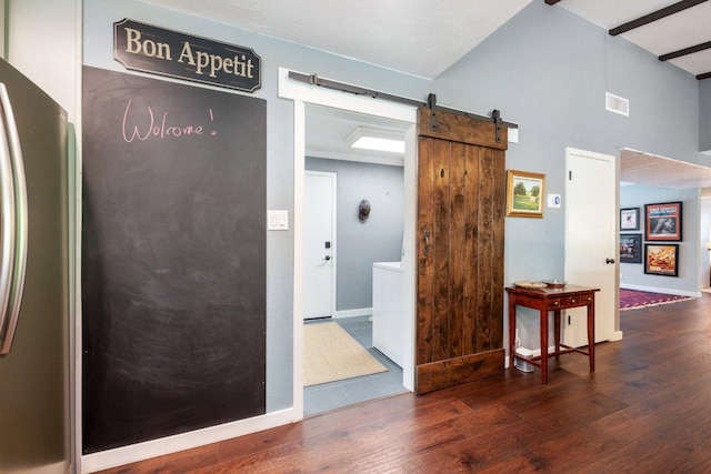 5310 Fort Clark Dr, Austin, TX 78745 - hall with a barn door, wood finished floors, and baseboards