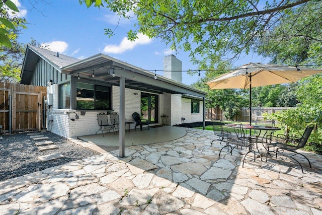 5310 Fort Clark Dr, Austin, TX 78745 - fenced backyard featuring a patio, outdoor dining area, and a gate