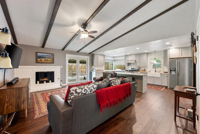 5310 Fort Clark Dr, Austin, TX 78745 - living room with ceiling fan, a brick fireplace, dark wood-style floors, and recessed lighting