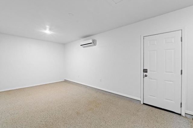 7003 Priscilla Dr, Austin, TX 78752 - spare room featuring a wall mounted AC and speckled floor