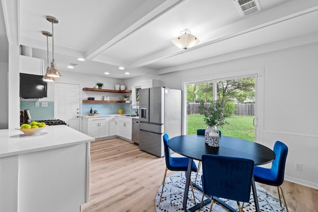 7003 Priscilla Dr, Austin, TX 78752 - dining area with beamed ceiling, recessed lighting, and light wood finished floors