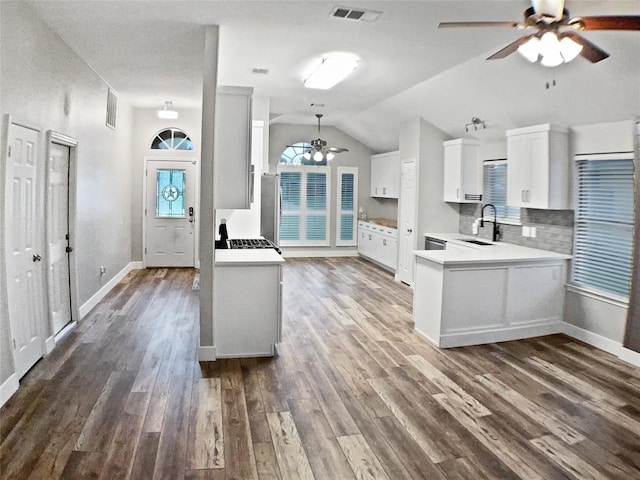 1608 Mallard Ln, Taylor, TX 76574 - kitchen featuring a ceiling fan, dark wood-type flooring, light countertops, lofted ceiling, and white cabinetry