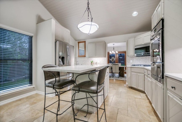 7306 Fireoak Dr, Austin, TX 78759 - kitchen with stainless steel appliances, a warming drawer, backsplash, a breakfast bar, and light countertops