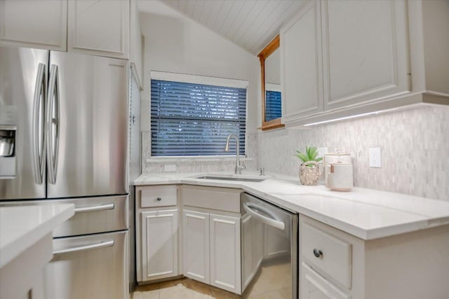 7306 Fireoak Dr, Austin, TX 78759 - kitchen with stainless steel appliances, lofted ceiling, decorative backsplash, white cabinetry, and light stone counters