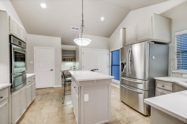 7306 Fireoak Dr, Austin, TX 78759 - kitchen featuring a warming drawer, stainless steel appliances, a kitchen island, stone tile floors, and pendant lighting