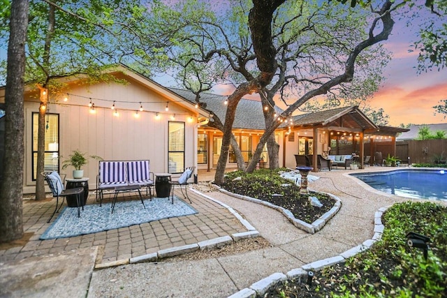 7306 Fireoak Dr, Austin, TX 78759 - back of house at dusk with outdoor lounge area and a patio area
