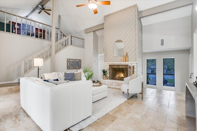 7306 Fireoak Dr, Austin, TX 78759 - living area featuring high vaulted ceiling, stone tile floors, a ceiling fan, and stairs