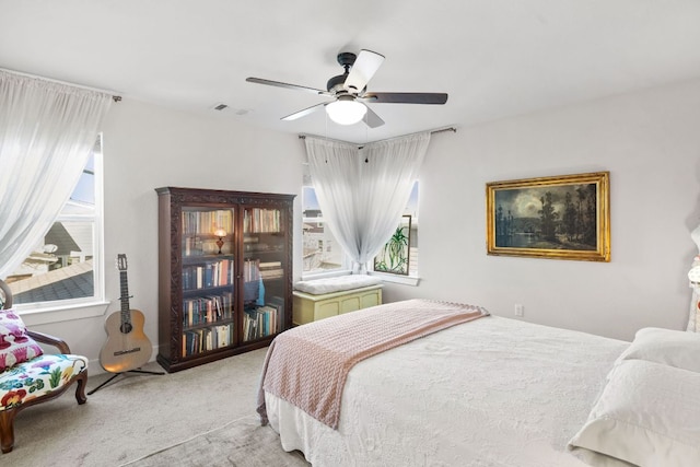 1900 Teagle Dr, Austin, TX 78741 - bedroom featuring multiple windows, carpet, and a ceiling fan