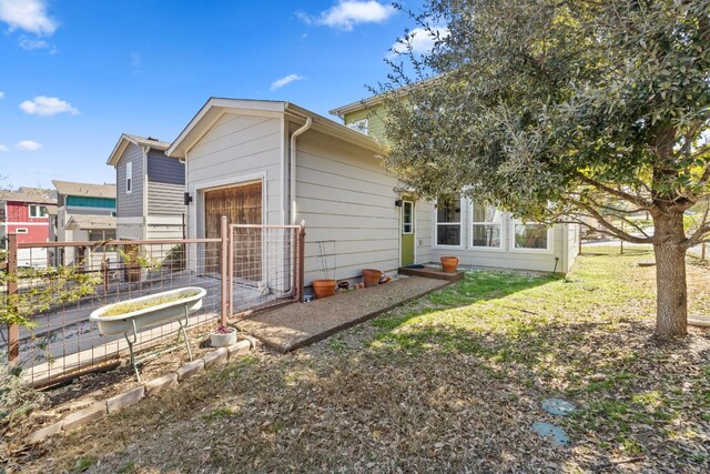 1900 Teagle Dr, Austin, TX 78741 - rear view of property featuring a vegetable garden