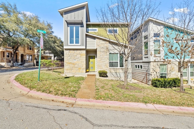 1900 Teagle Dr, Austin, TX 78741 - view of front of house featuring stone siding, board and batten siding, and a front yard