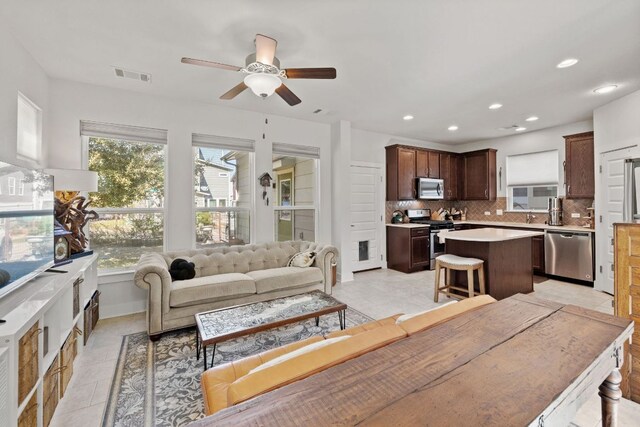 1900 Teagle Dr, Austin, TX 78741 - living area featuring a ceiling fan, recessed lighting, and light tile patterned flooring