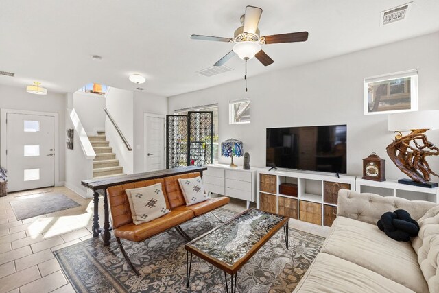 1900 Teagle Dr, Austin, TX 78741 - living room featuring stairway, ceiling fan, tile patterned floors, and baseboards