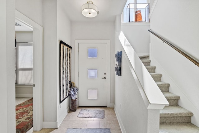 1900 Teagle Dr, Austin, TX 78741 - foyer featuring baseboards, stairway, and light tile patterned floors