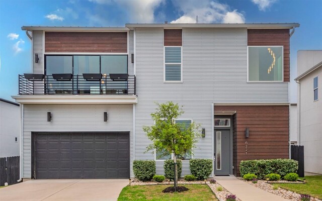 6221 Florencia Ln, Austin, TX 78724 - contemporary home featuring a balcony, an attached garage, and driveway