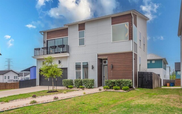 6221 Florencia Ln, Austin, TX 78724 - contemporary house with a balcony, an attached garage, and concrete driveway