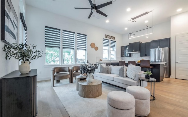 6221 Florencia Ln, Austin, TX 78724 - living area with light wood-style flooring, ceiling fan, and recessed lighting
