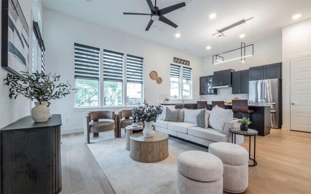 6221 Florencia Ln, Austin, TX 78724 - living area with light wood finished floors, ceiling fan, and recessed lighting