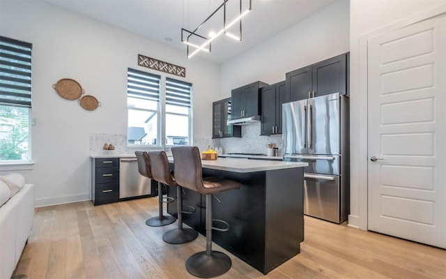 6221 Florencia Ln, Austin, TX 78724 - kitchen with stainless steel appliances, light wood-style flooring, and light countertops